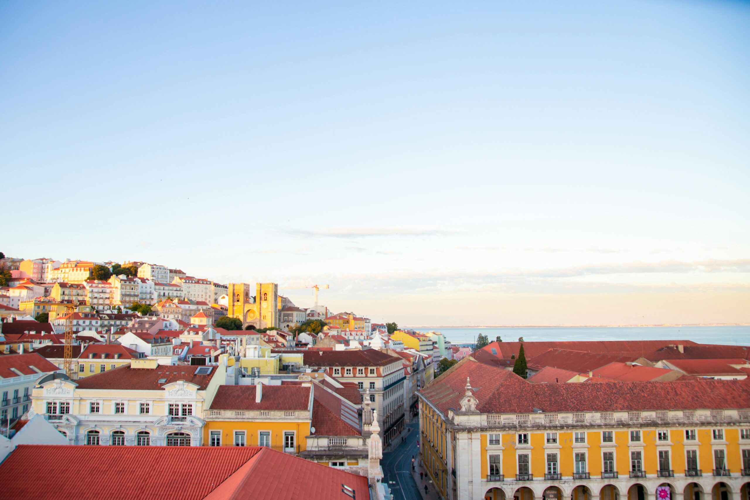 Experience Lisbon's stunning architecture and vibrant colors with a coastal backdrop.