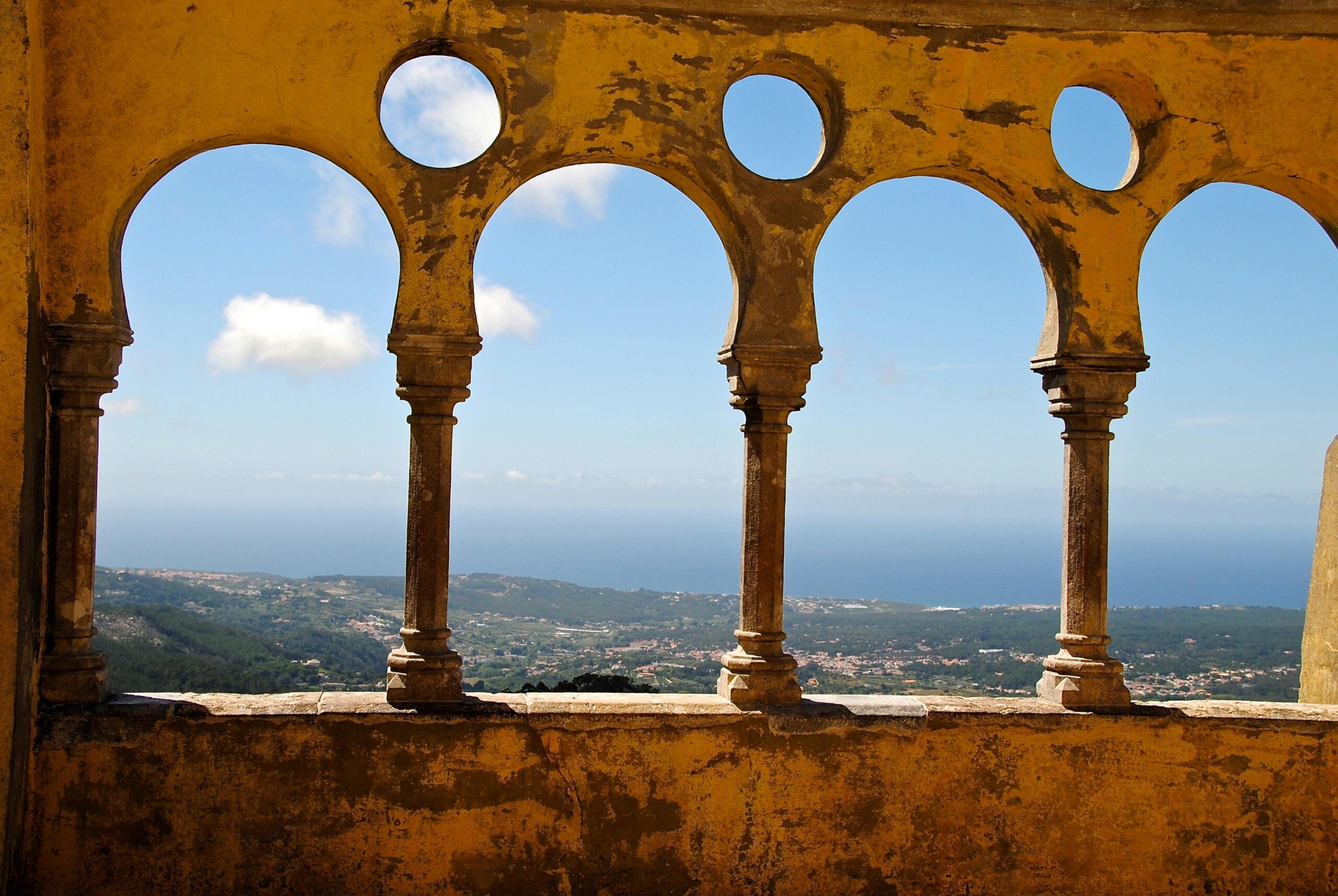 Gorgeous ocean view through vintage arches at Sintra Palace, Portugal.