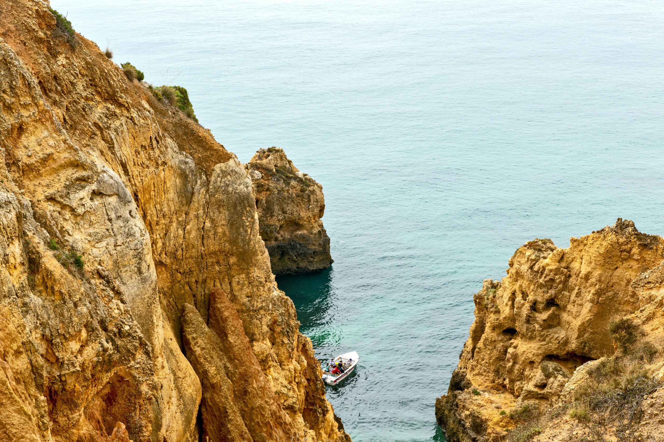 Explore the stunning cliffs and serene ocean near Lagos, Portugal, perfect for travel inspiration.
