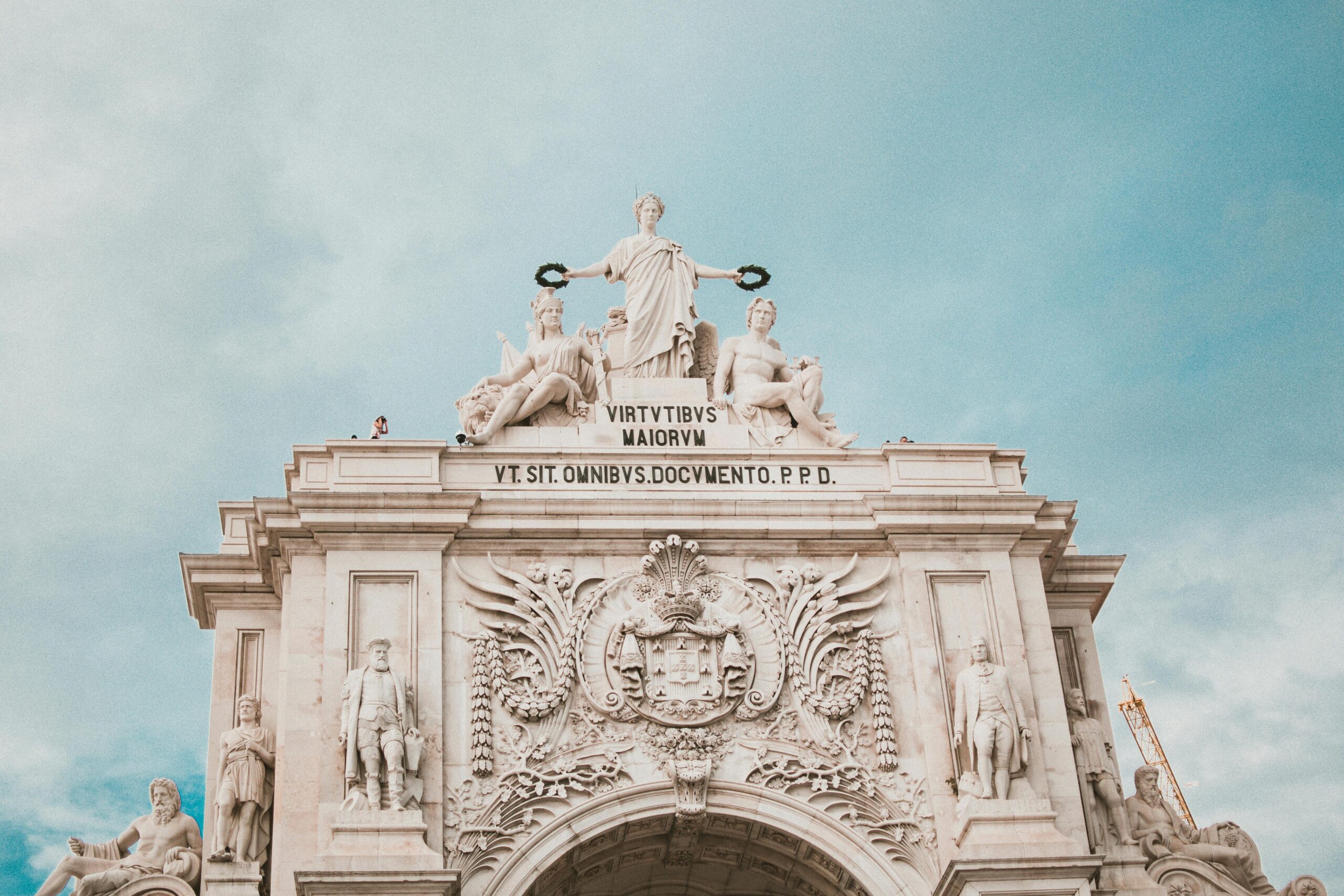Low angle view of the iconic Rua Augusta Arch in Lisbon, showcasing its historic architecture.