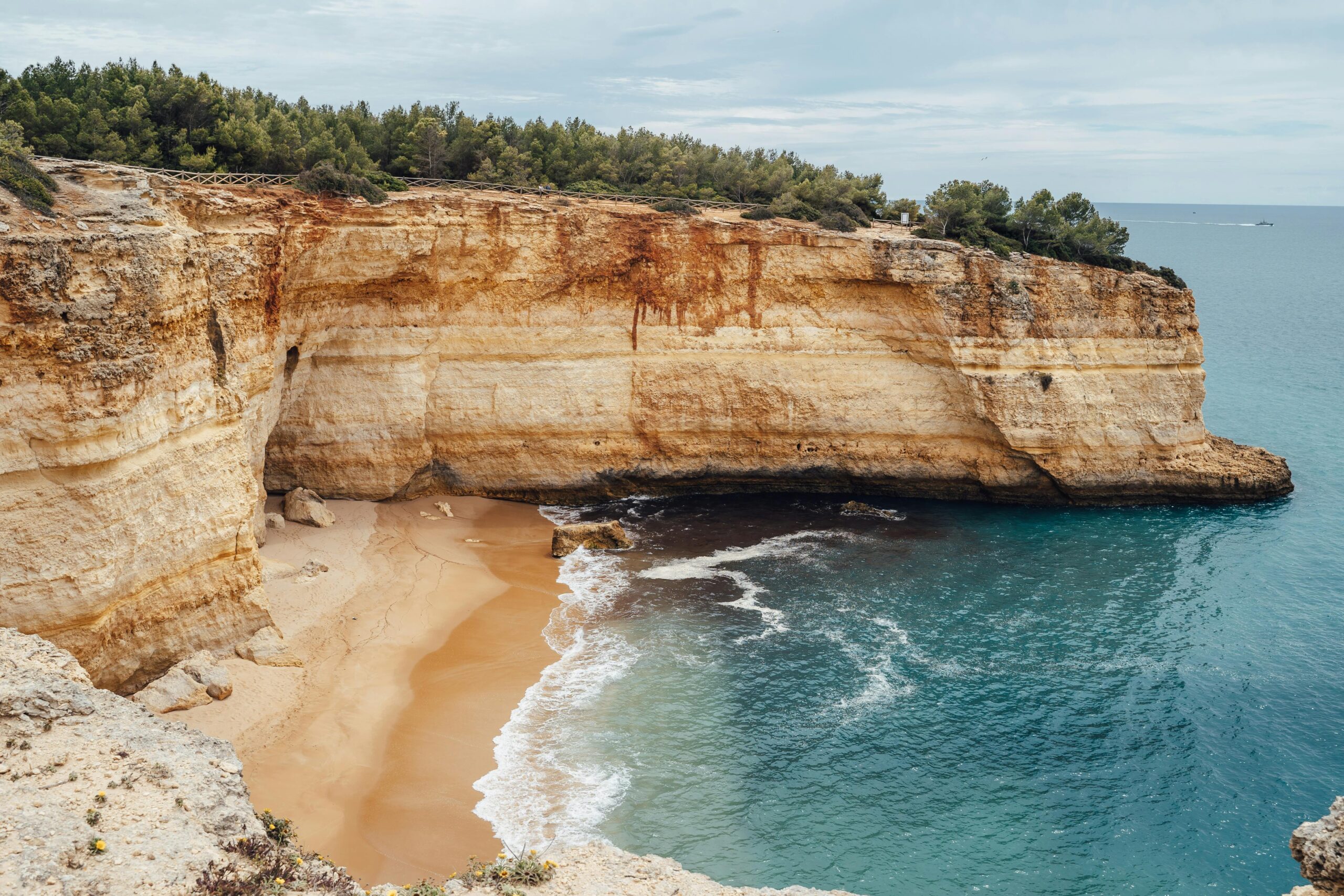 Beautiful coastal cliffs and beach at Praia da Corredoura, Portugal; serene and picturesque.